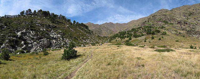 GR11 crossing the high meadow towards Les Canyorques and Coma Pedrosa.