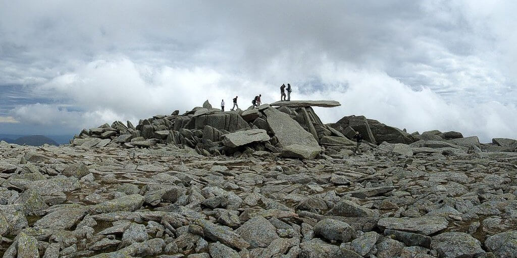 Hikers on the Cantilever Stone, Glyder Fach, Snowdonia, Welsh Mountains.